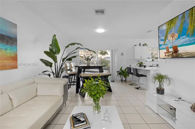 a living room with furniture flowerpot and flower pot