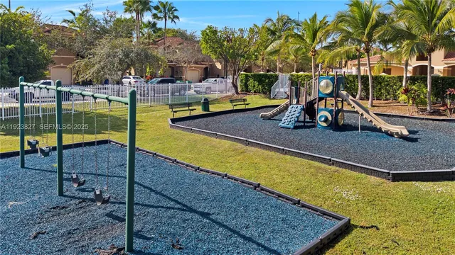 a view of a swimming pool with a patio and fire pit