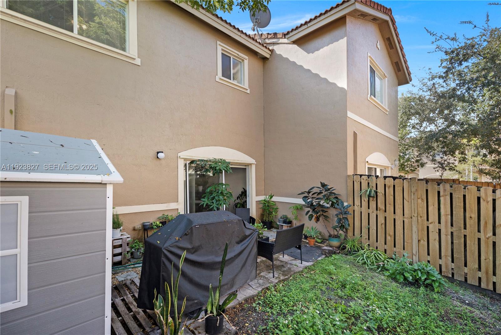 8525 Southwest 214th Terrace Cutler Bay, FL 33189 - Photo 5 of 35 a view of a patio with table and chairs and potted plants