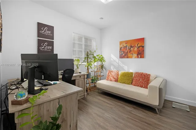 a living room with furniture and a wooden floor