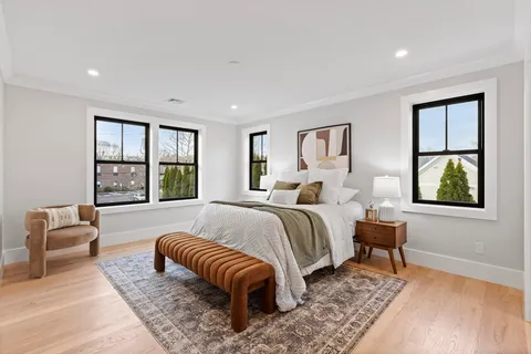 a spacious bedroom with a bed and a large window