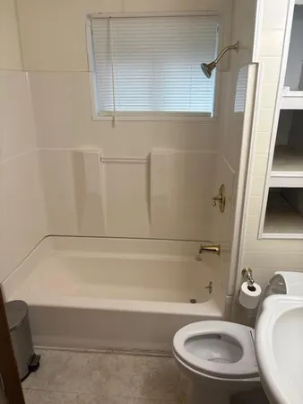 a bathroom with a sink a toilet and bathtub