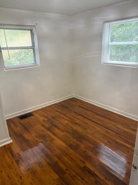 102 Carver Avenue Northwest Roanoke, VA 24012 - Photo 7 of 14 an empty room with wooden floor and windows