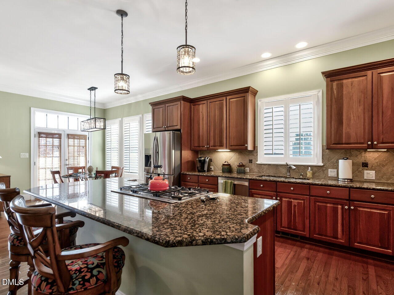 8409 Passage Marseille Court Raleigh, NC 27615 - Photo 12 of 48 a kitchen with granite countertop a sink stove and cabinets