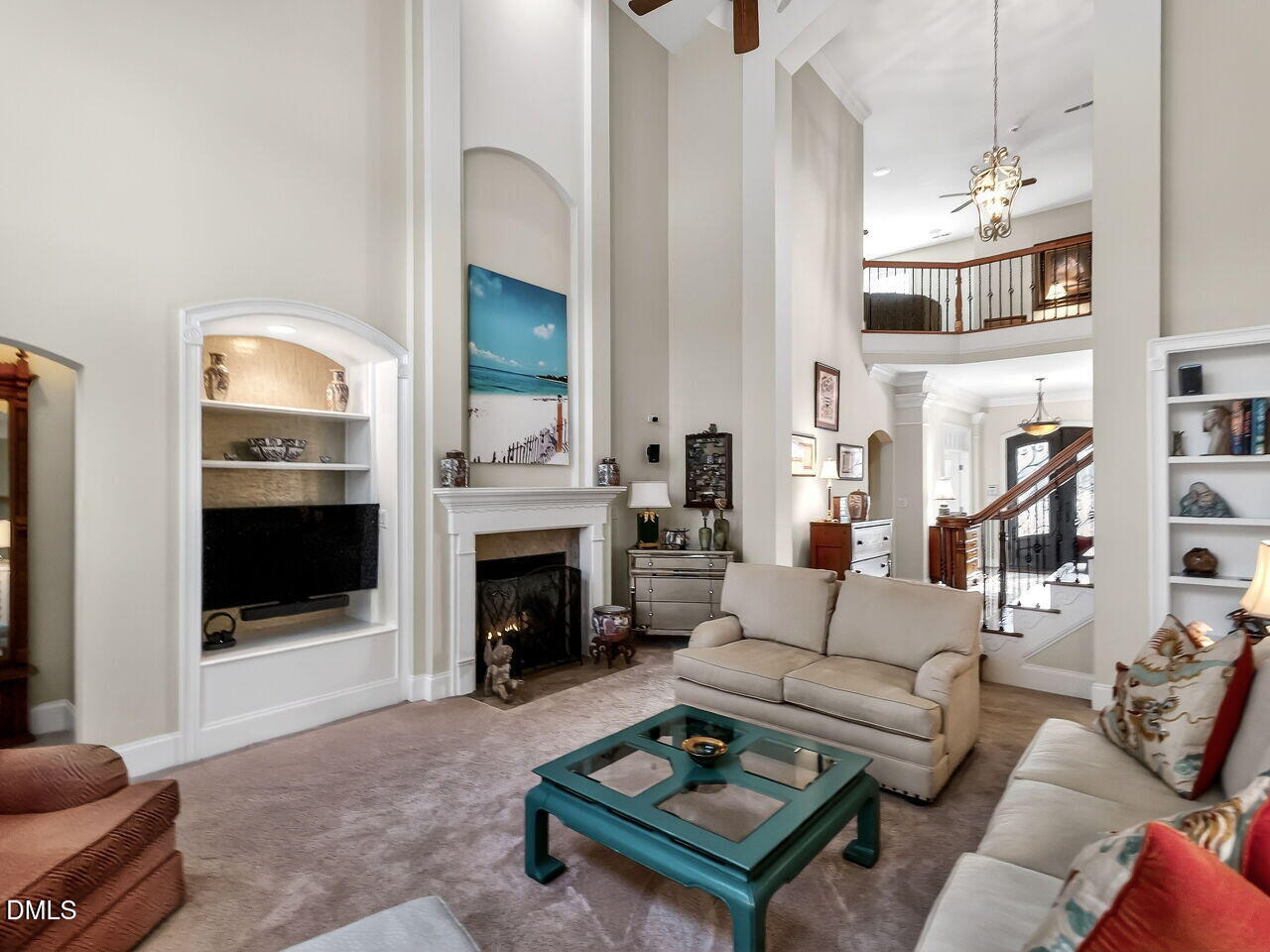8409 Passage Marseille Court Raleigh, NC 27615 - Photo 17 of 48 a living room with furniture a fireplace and a flat screen tv