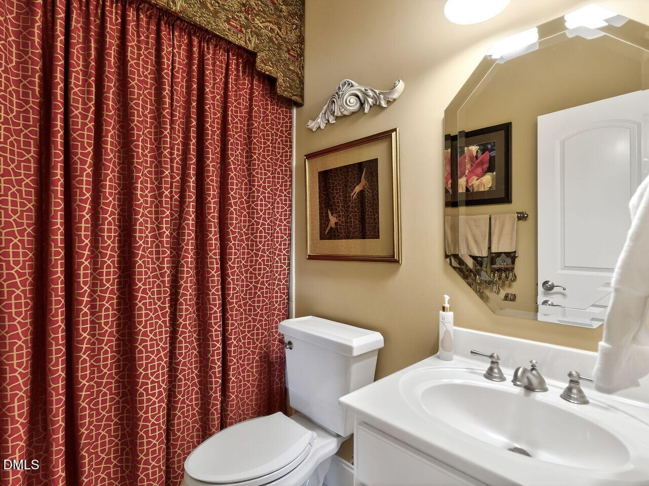 8409 Passage Marseille Court Raleigh, NC 27615 - Photo 21 of 48 a bathroom with a toilet a sink and mirror