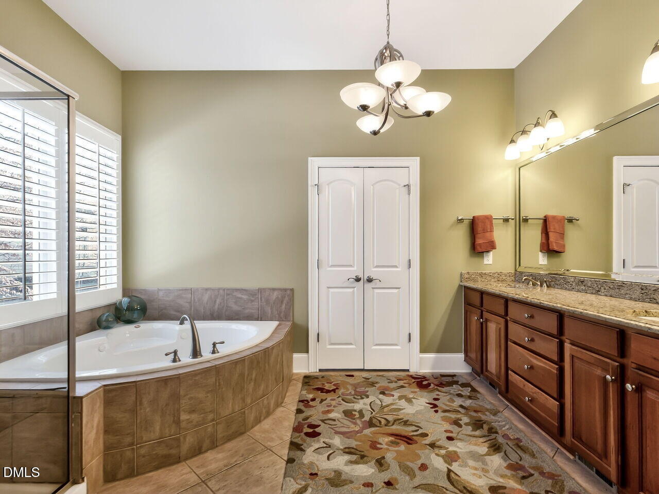8409 Passage Marseille Court Raleigh, NC 27615 - Photo 24 of 48 a bathroom with a tub sink and mirror