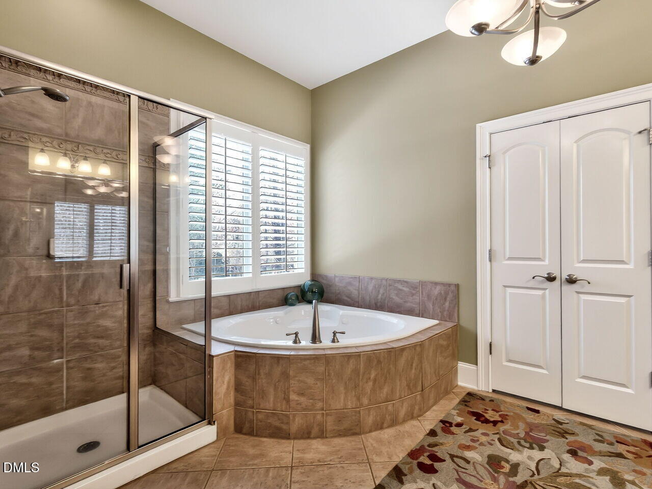 8409 Passage Marseille Court Raleigh, NC 27615 - Photo 25 of 48 a bathroom with a tub and shower