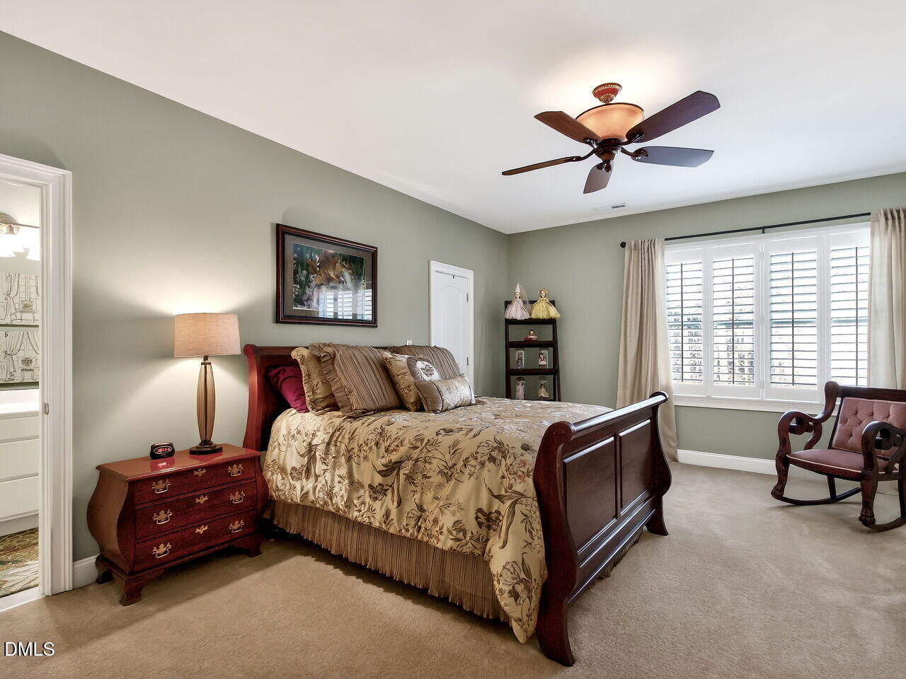 8409 Passage Marseille Court Raleigh, NC 27615 - Photo 28 of 48 a spacious bedroom with a bed and a chandelier