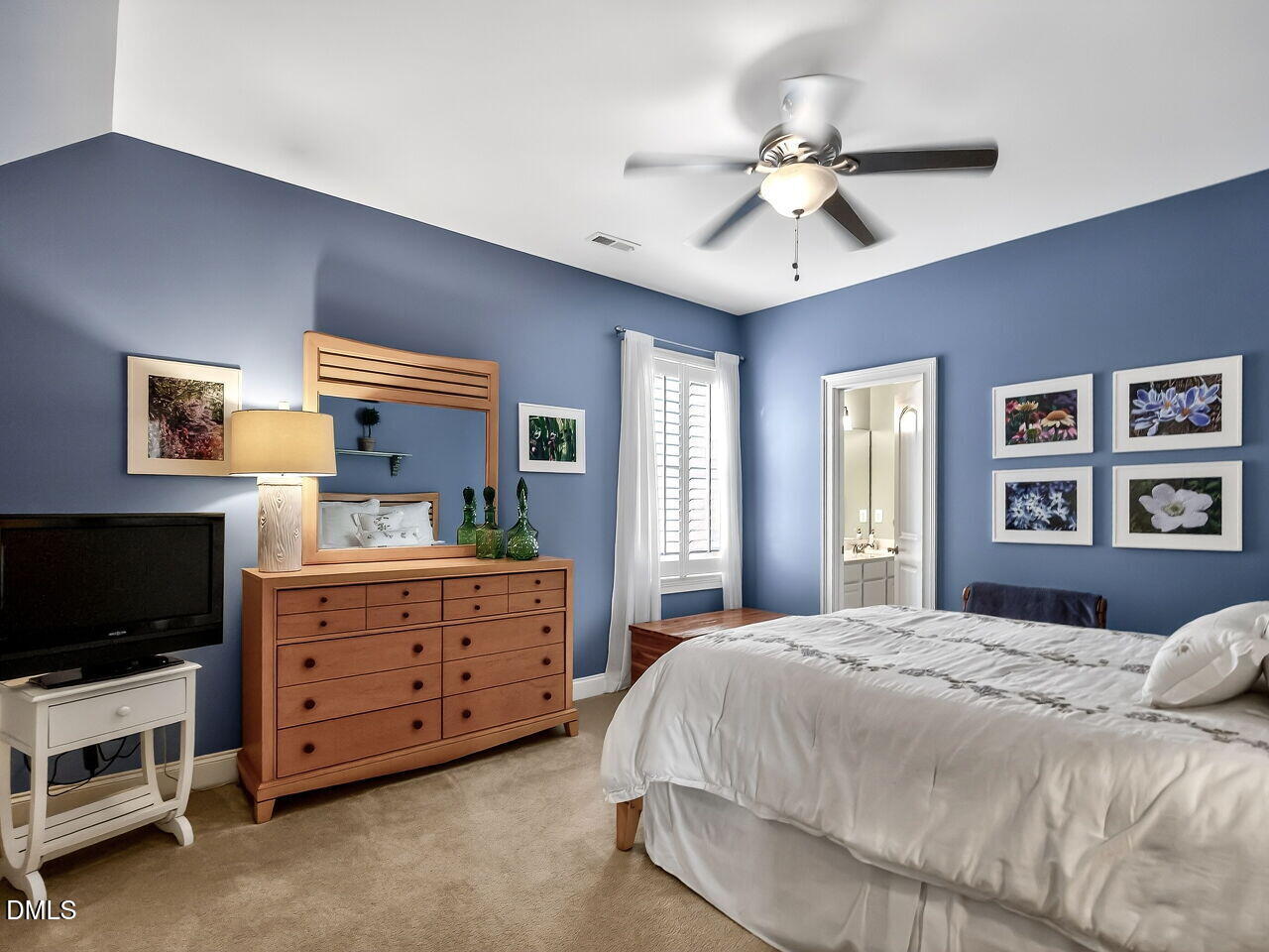 8409 Passage Marseille Court Raleigh, NC 27615 - Photo 29 of 48 a bedroom with a bed and a flat screen tv