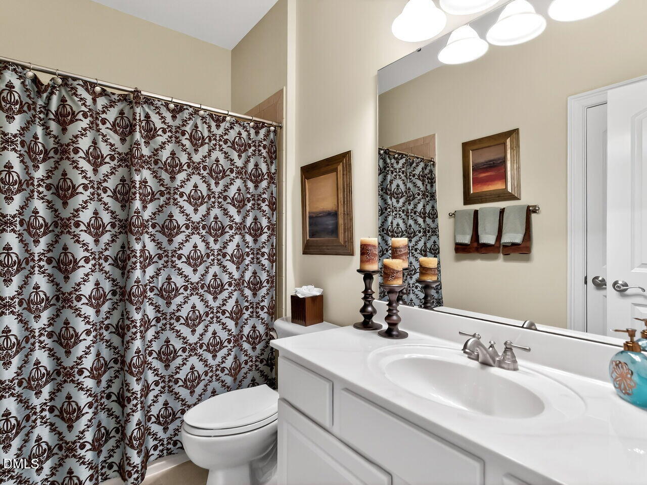 8409 Passage Marseille Court Raleigh, NC 27615 - Photo 34 of 48 a bathroom with a sink a toilet and a mirror