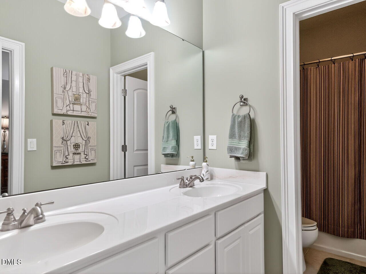 8409 Passage Marseille Court Raleigh, NC 27615 - Photo 35 of 48 a bathroom with a sink and a mirror