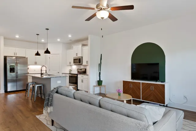a living room with furniture and a wooden floor