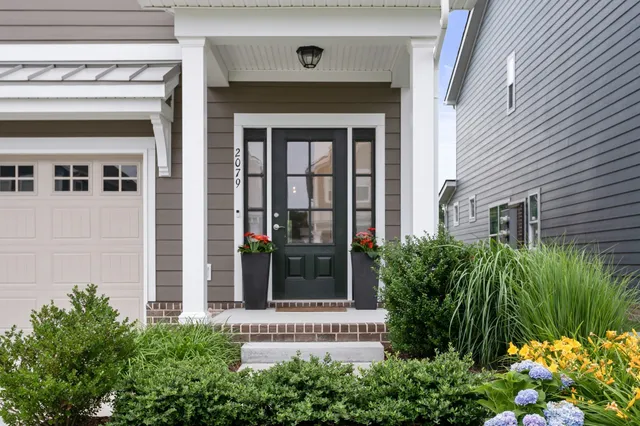 a front view of a house with a garden