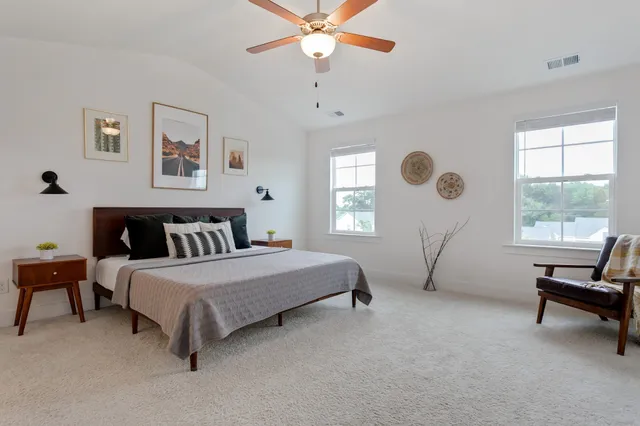 a spacious bedroom with a bed and a window