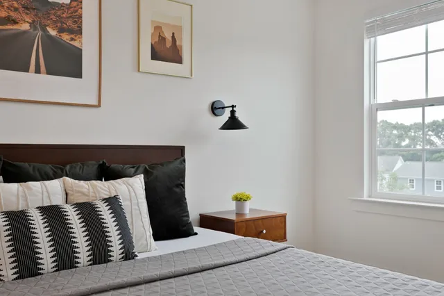 a bedroom with a bed and window