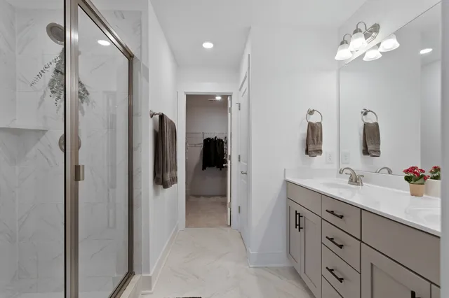 a bathroom with a double vanity sink shower and mirror