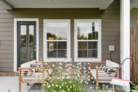 a front view of a house with outdoor seating