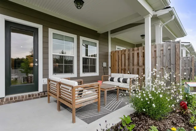 a wooden bench sitting in front of a building