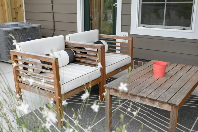 a balcony with table and chairs