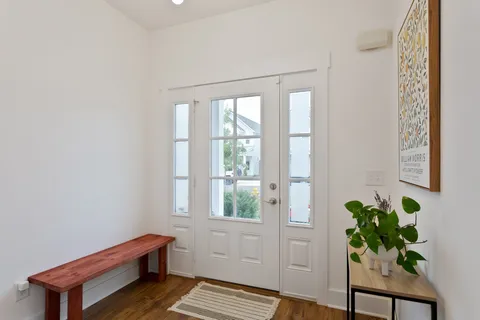 a room with window and a potted plant