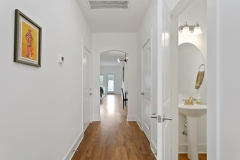 a view of a hallway with wooden floor