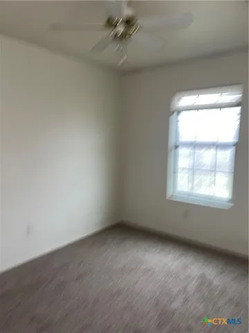 a bathroom with a granite countertop bathtub shower and toilet