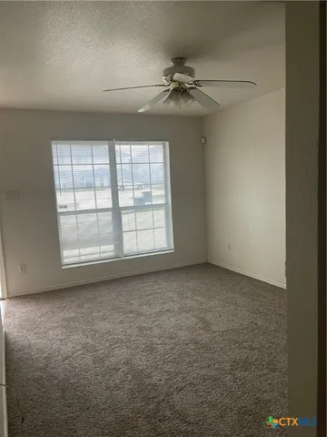 an empty room with a empty space and windows