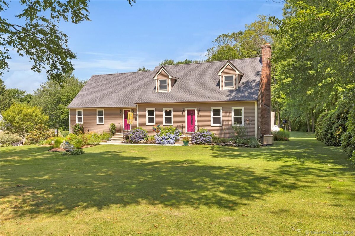 a front view of a house with swimming pool having outdoor seating