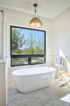 a spacious bathroom with a granite countertop sink and a mirror