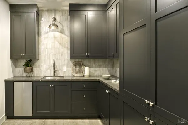 a en suite bathroom with a granite countertop sink and a mirror