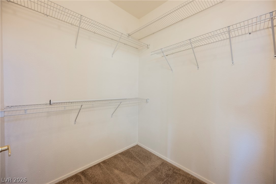 6320 Snap Ridge Street, Unit 201 North Las Vegas, NV 89081 - Photo 31 of 56 Ample wire shelving provides practical storage within this walk-in closet.
