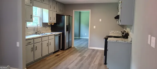 a kitchen with a refrigerator and a sink