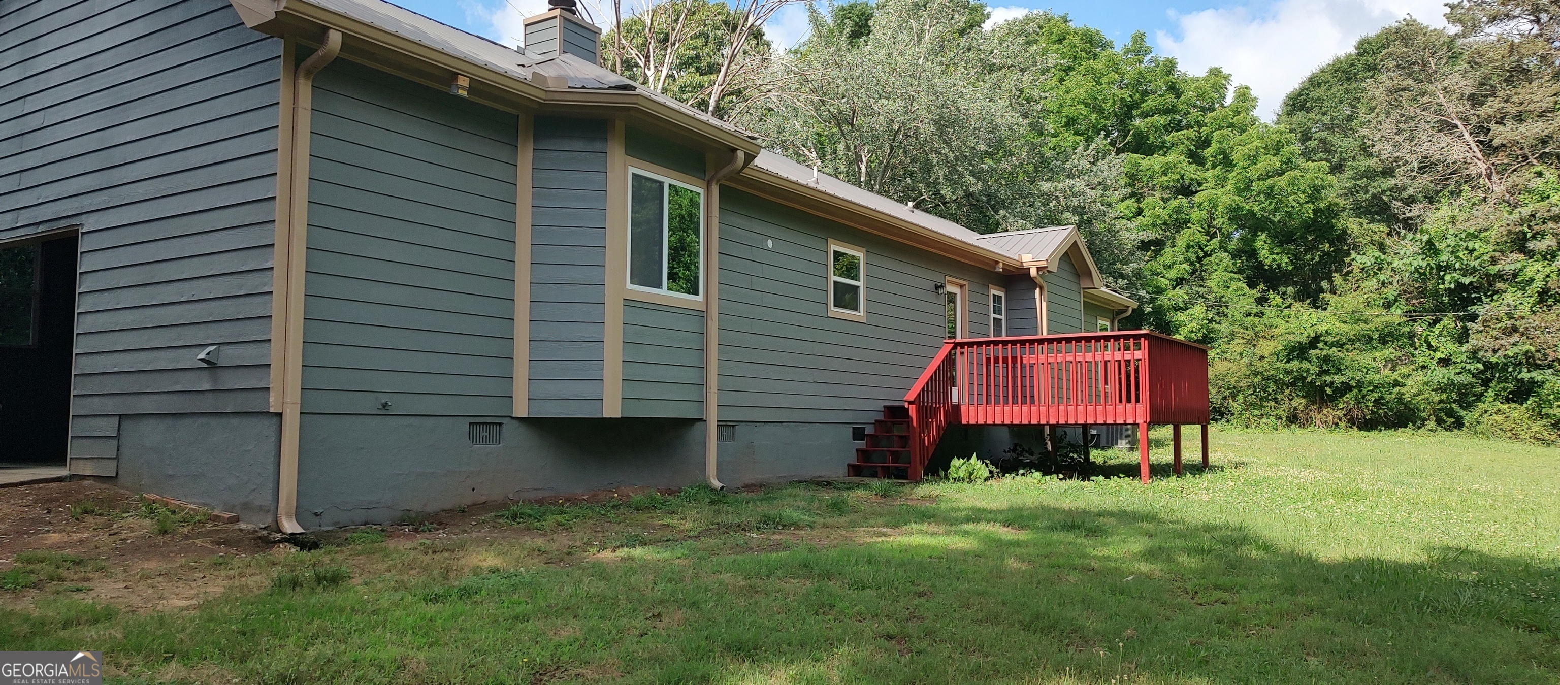 356 Mays Road Stockbridge, GA 30281 - Photo 9 of 9 a backyard of a house with wooden fence and a toy car