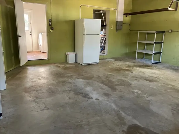 a view of a room with refrigerator and washer