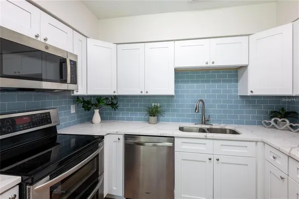 a kitchen with a sink and cabinets