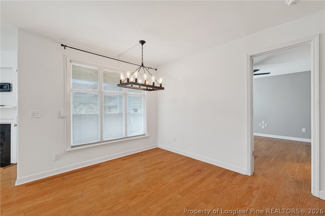 1221 Westview Lane, Unit 301 Raleigh, NC 27605 - Photo 6 of 32 a view of a room with a chandelier fan and windows