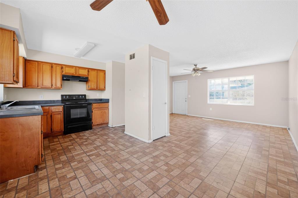 540 Pine Court Altamonte Springs, FL 32714 - Photo 18 of 30 a kitchen with granite countertop a stove a sink and a refrigerator