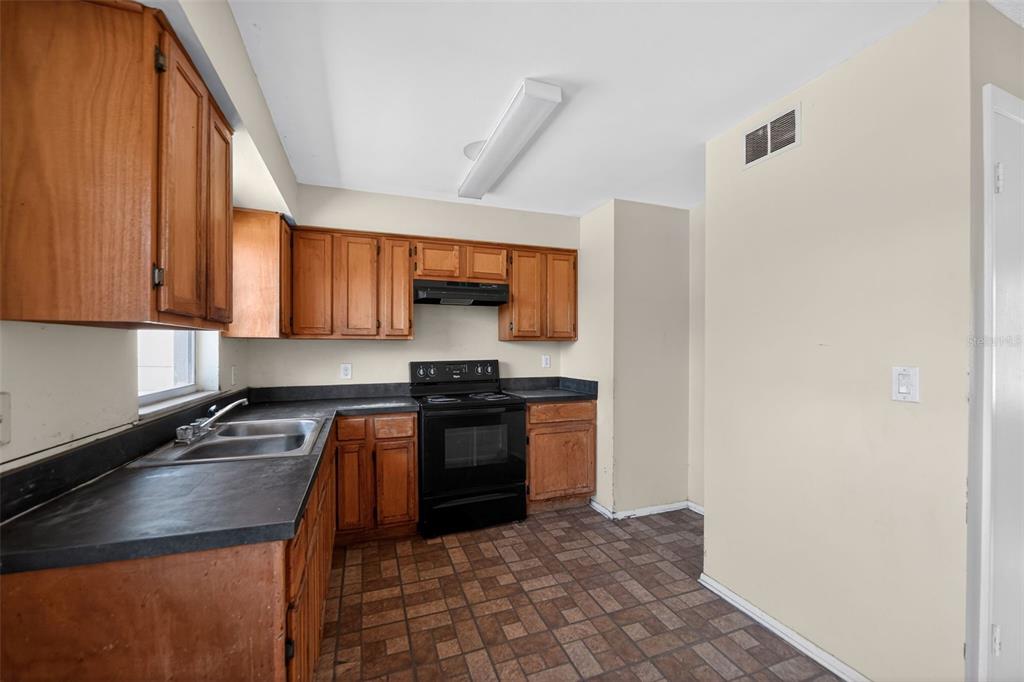 540 Pine Court Altamonte Springs, FL 32714 - Photo 19 of 30 a kitchen with stainless steel appliances granite countertop a stove a sink and a microwave