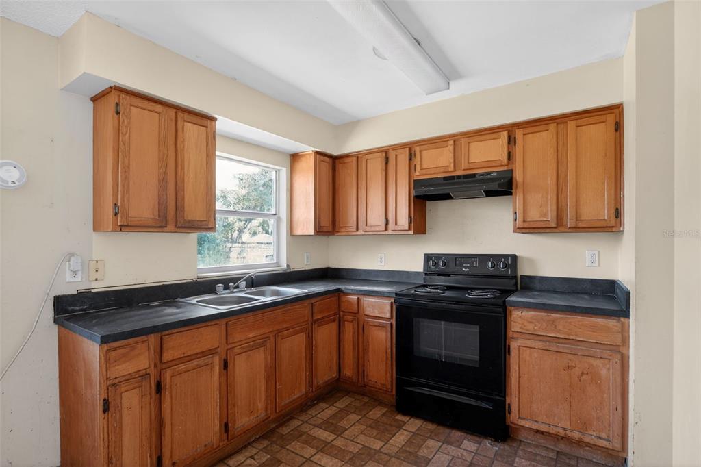 540 Pine Court Altamonte Springs, FL 32714 - Photo 20 of 30 a kitchen with stainless steel appliances granite countertop a stove sink and cabinets