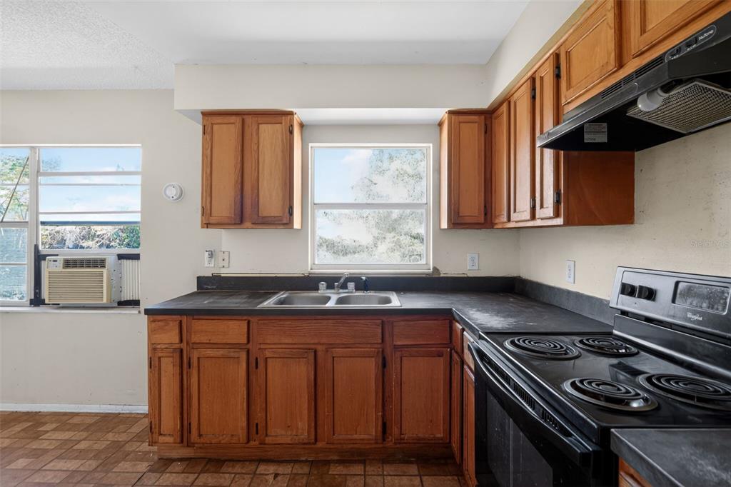 540 Pine Court Altamonte Springs, FL 32714 - Photo 22 of 30 a kitchen with granite countertop a stove sink and cabinets