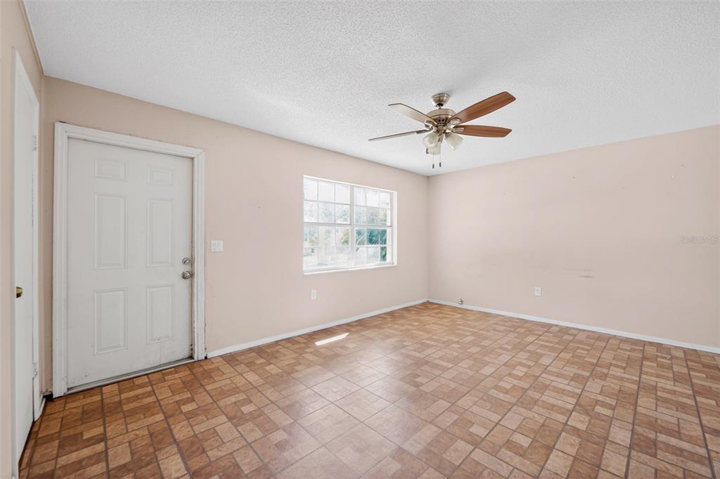 540 Pine Court Altamonte Springs, FL 32714 - Photo 8 of 30 a view of a big room with windows and chandelier fan