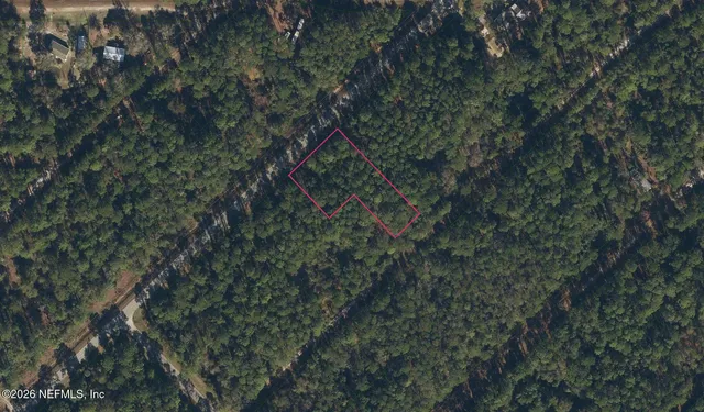 a backyard of a house with lots of trees