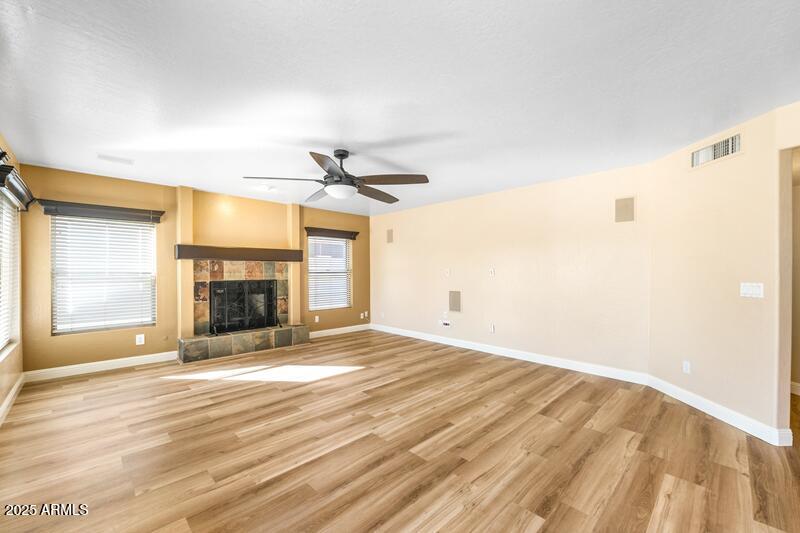 1691 West Commerce Avenue Gilbert, AZ 85233 - Photo 10 of 34 a view of empty room with fireplace and wooden floor