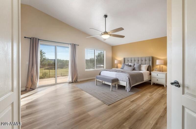 1691 West Commerce Avenue Gilbert, AZ 85233 - Photo 19 of 34 a bedroom with a bed wooden floor and a window