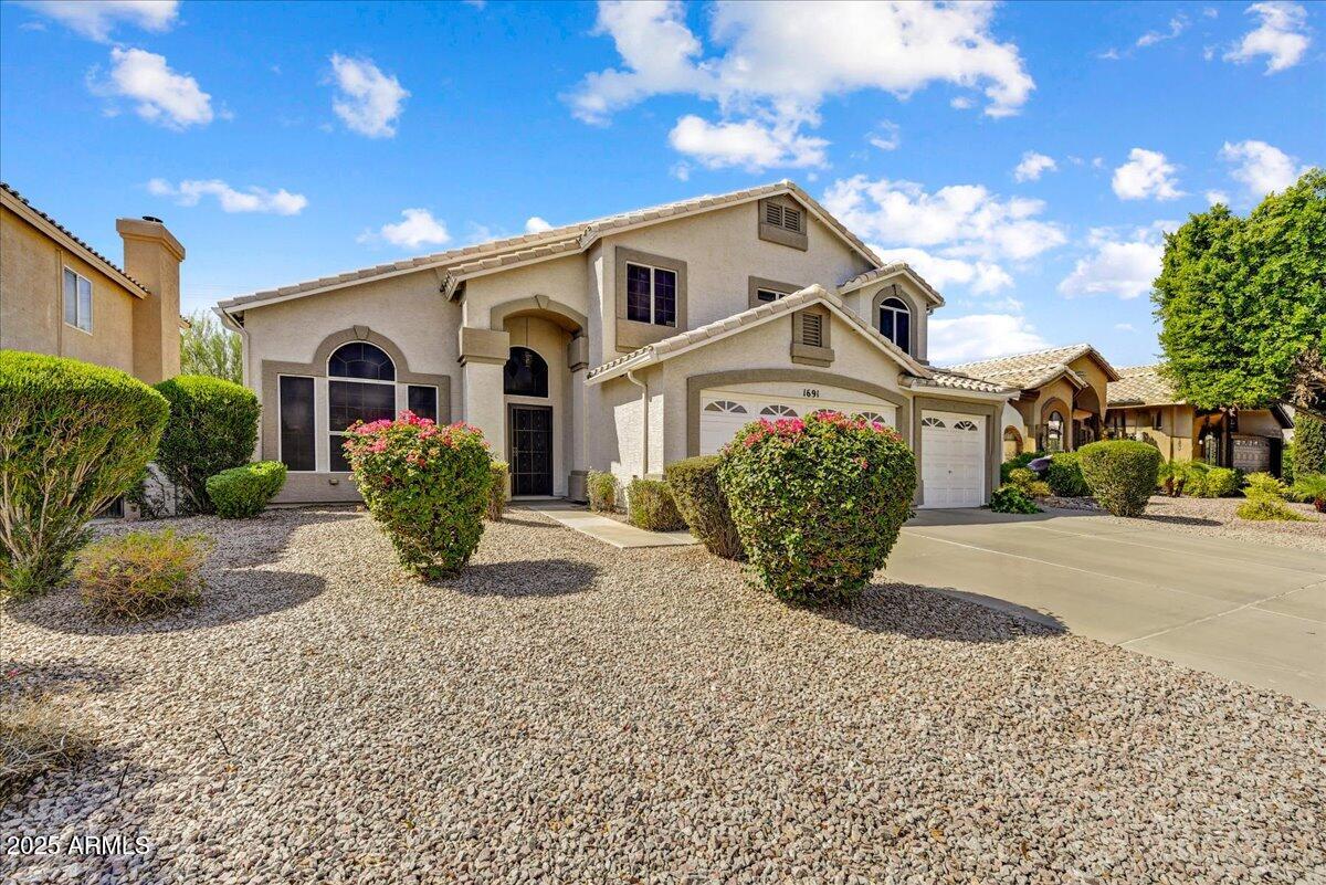 1691 West Commerce Avenue Gilbert, AZ 85233 - Photo 2 of 34 a view of a house with a yard