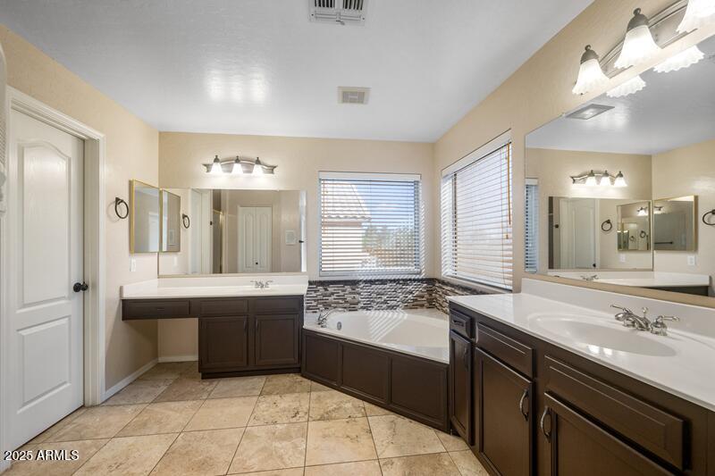 1691 West Commerce Avenue Gilbert, AZ 85233 - Photo 21 of 34 a large bathroom with a sink and a large mirror