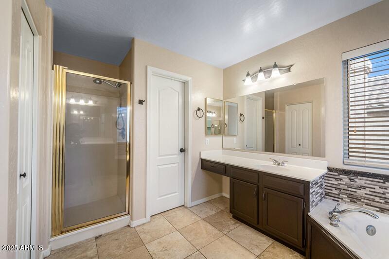 1691 West Commerce Avenue Gilbert, AZ 85233 - Photo 22 of 34 a spacious bathroom with a double vanity sink mirror and shower