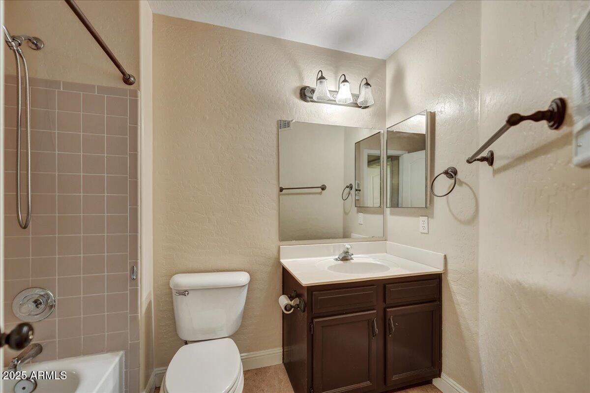 1691 West Commerce Avenue Gilbert, AZ 85233 - Photo 25 of 34 a bathroom with a sink a toilet a mirror and shower