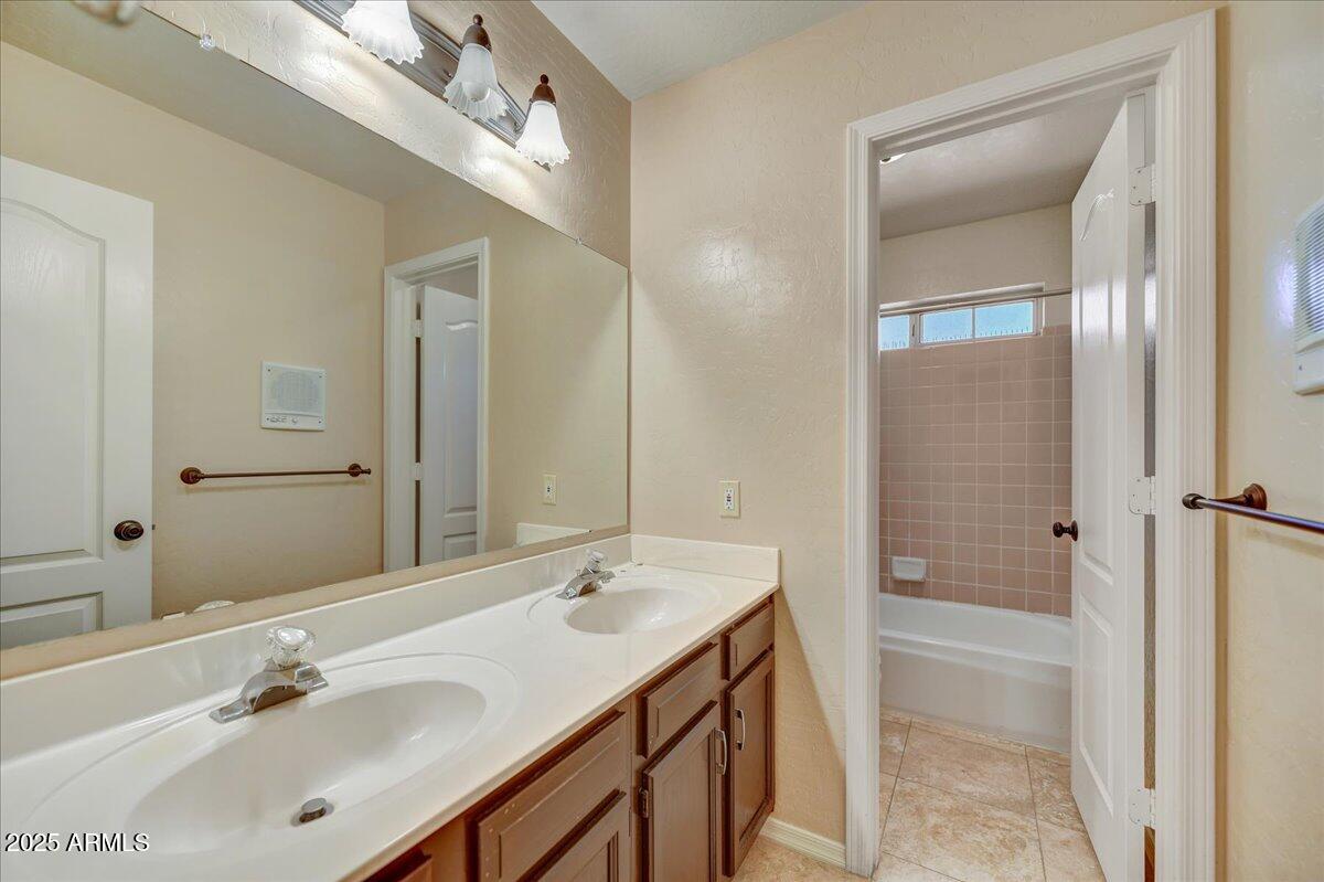 1691 West Commerce Avenue Gilbert, AZ 85233 - Photo 27 of 34 a bathroom with a sink a shower and a mirror